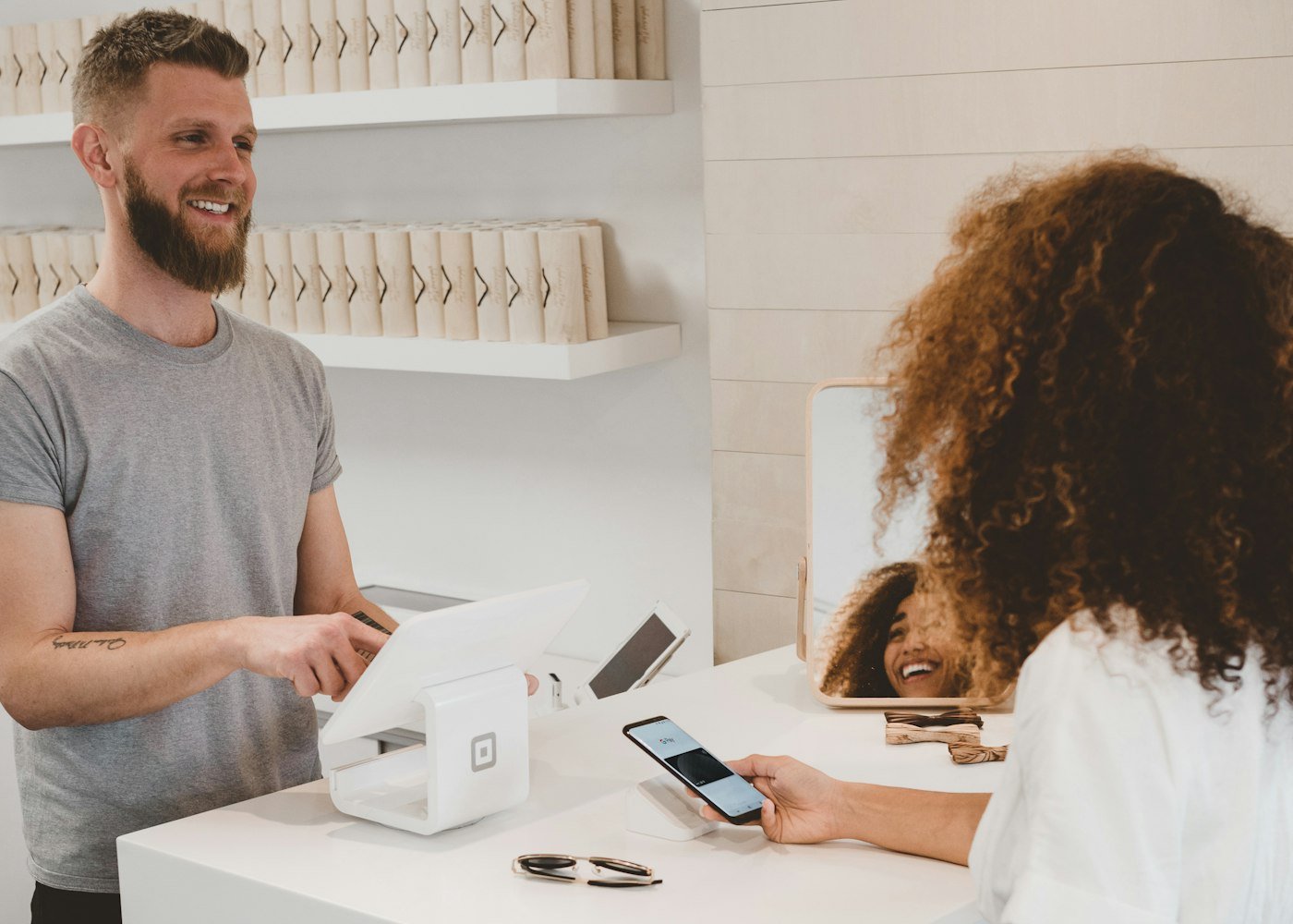 Retailer accepting payment at shop counter