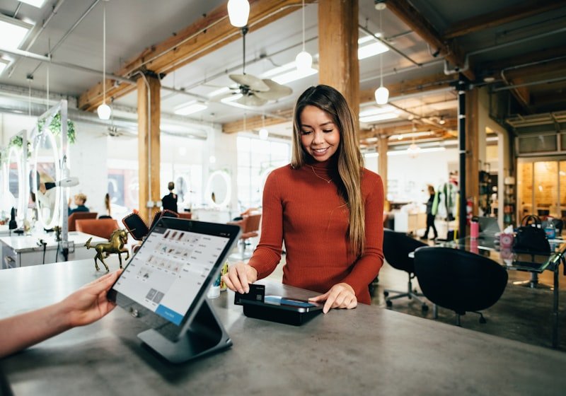 Shop owner using phone at counter